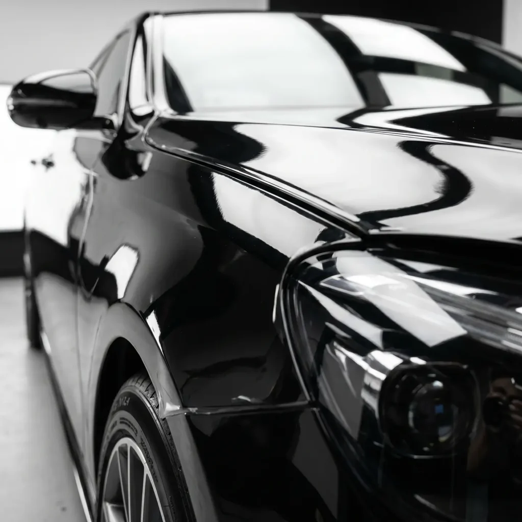 Glossy black car with flawless XPEL paint protection film finish at Stay Cool Tinting Calgary.